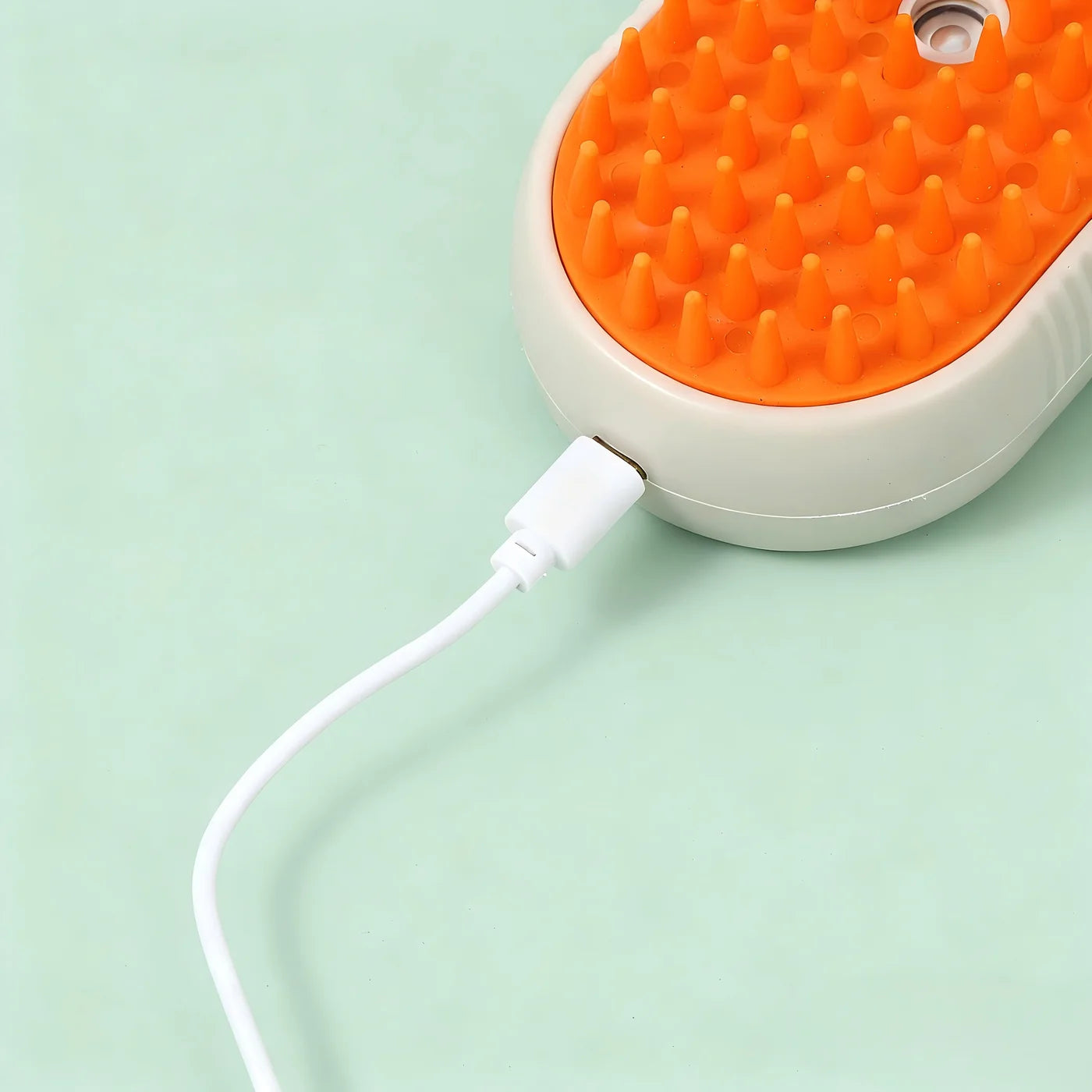 Escova Nivora Pets cor laranja a carregar através de cabo USB